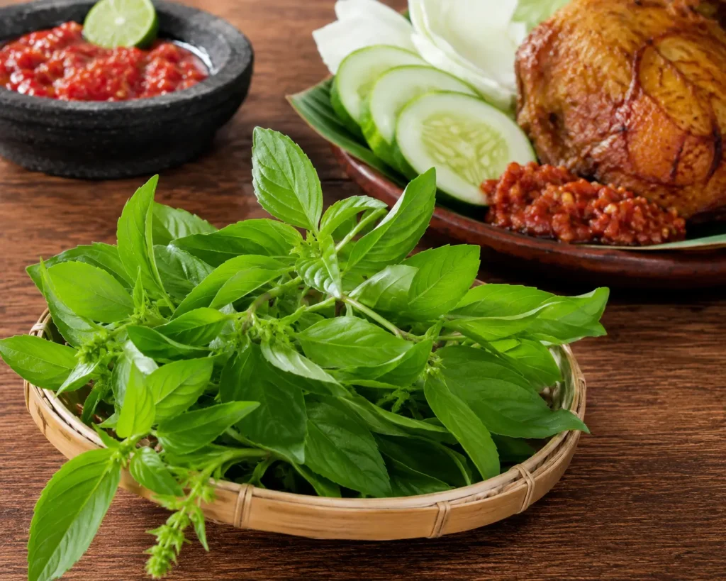 Daun Kemangi: Kenapa Selalu Jadi Lalapan dan Bedanya dengan Basil Daun kemangi segar berwarna hijau cerah di atas meja kayu sebagai lalapan pendamping makanan Indonesia